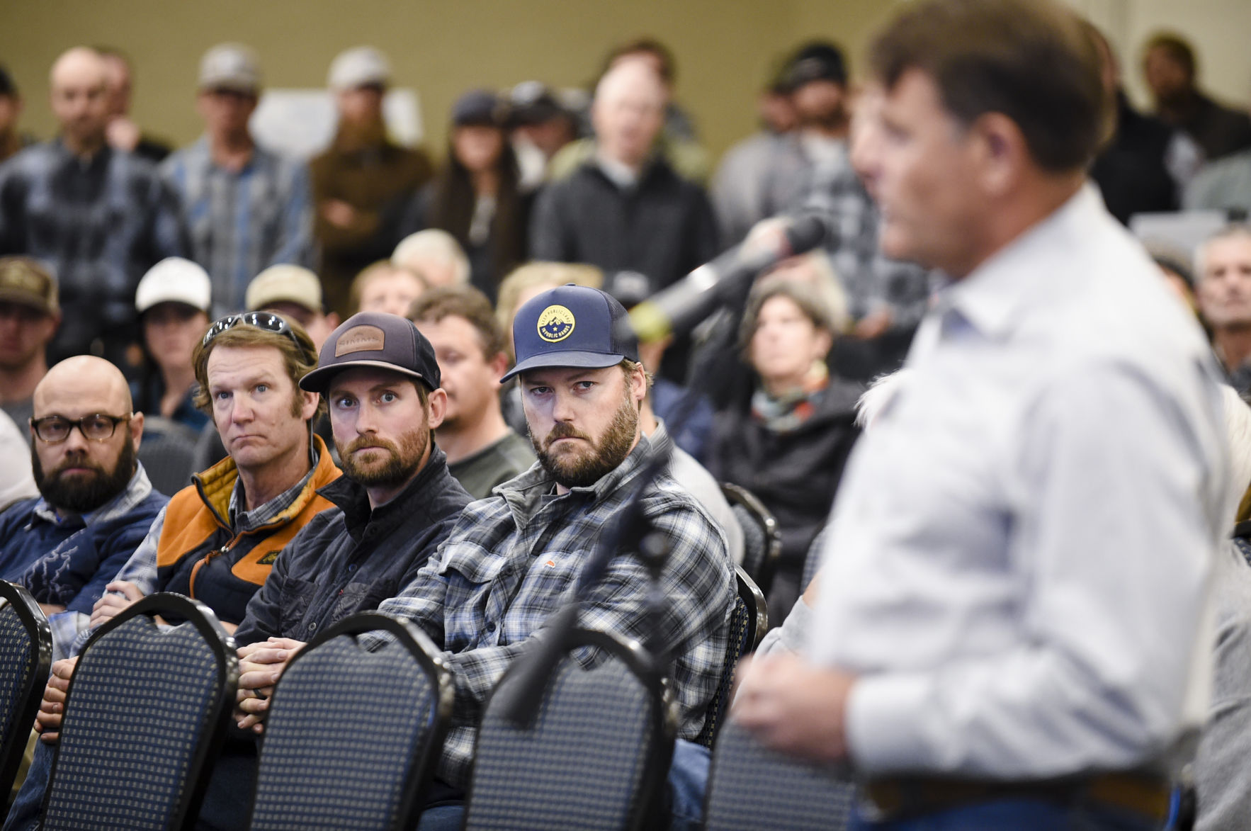 Meeting attendants listen to Sen. Terry Gauthier voice his support for the Black Butte Copper Mine during Monday's meeting.